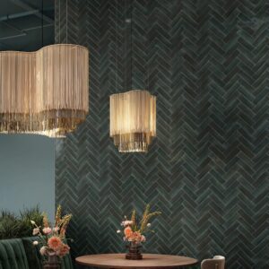 Upscale restaurant dining area featuring a modern accent wall installation with 2x8-inch brick-look tiles in the CB95 finish from the American Olean Conrad Brick collection.
