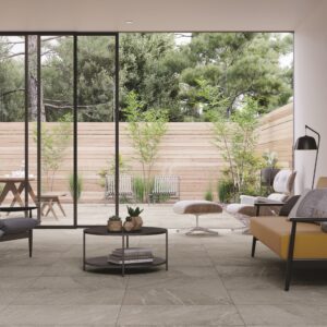 Elegant residential room installation featuring large-format stone-look porcelain flooring from the American Olean Montesano collection.