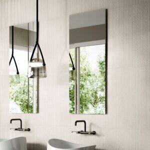 A contemporary bathroom washbasin vanity area featuring a clean wall backsplash tiled in soft off-white MILEstone Urban Living Pearl porcelain tiles.