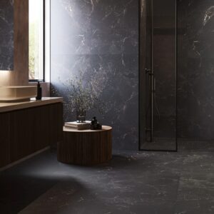 Deep black-brown large-format porcelain tile with dramatic natural marble veining from The Edge collection by Portobello being used in a modern bathroom.
