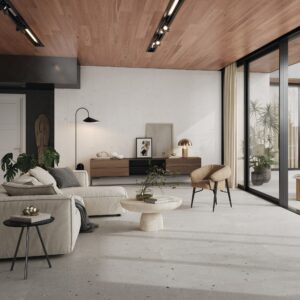 Contemporary living room setting featuring a modern floor installation of large-format 24x48-inch porcelain tiles in a seamless White and Light Grey color blend from the Klastos collection.