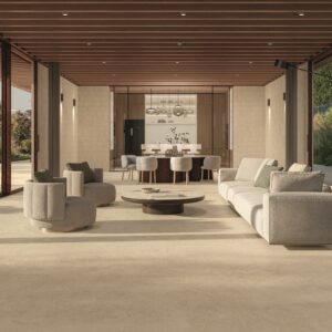 Modern open-concept living space, dining room, and kitchen featuring premium porcelain flooring in the Dune and Furnace Dune finishes from the Atlas Concorde Boost Icor collection.